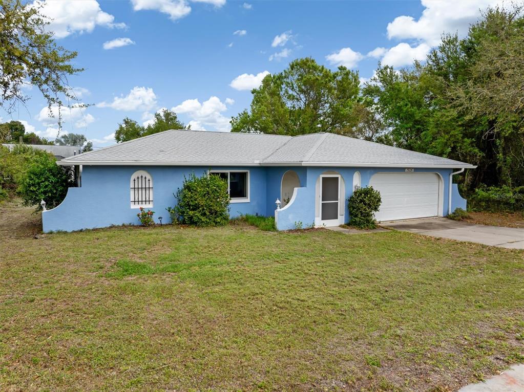 23226 Midway Boulevard Punta Gorda, FL 33980 - Photo 32 of 37 a front view of the house with garden