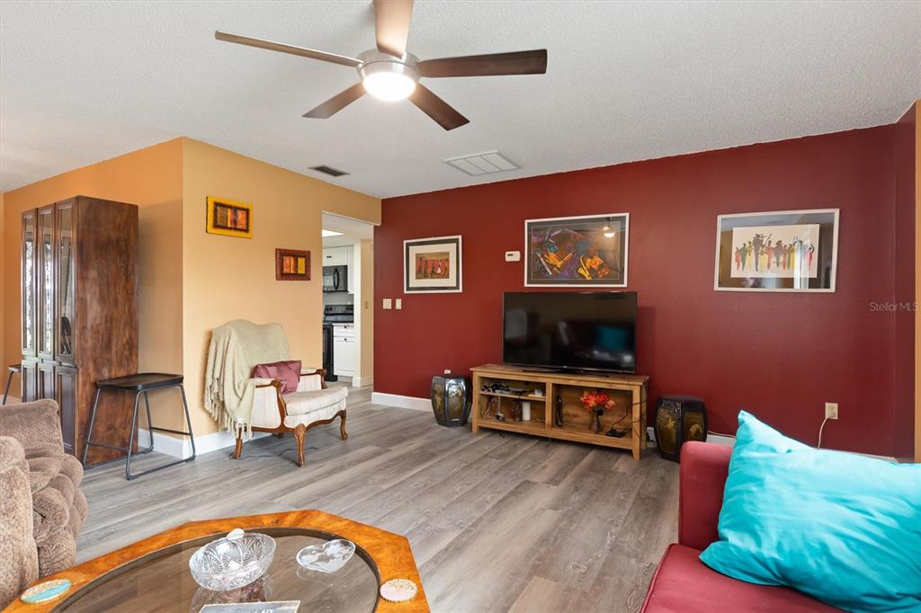 23226 Midway Boulevard Punta Gorda, FL 33980 - Photo 5 of 37 a living room with furniture and a flat screen tv
