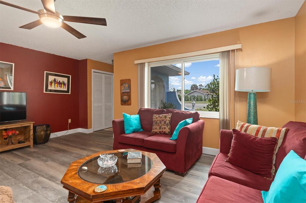 23226 Midway Boulevard Punta Gorda, FL 33980 - Photo 7 of 37 a living room with furniture a lamp and a flat screen tv