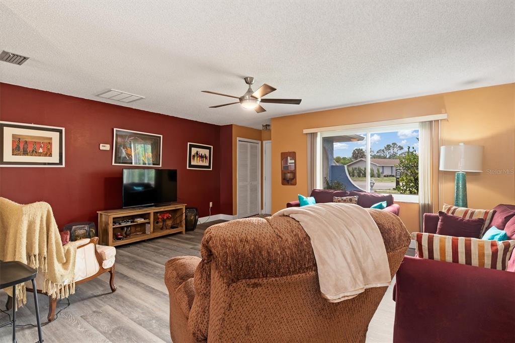 23226 Midway Boulevard Punta Gorda, FL 33980 - Photo 8 of 37 a bed room with furniture and a ceiling fan