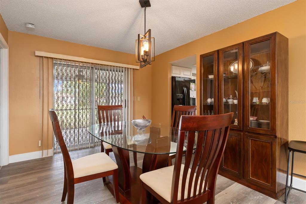 23226 Midway Boulevard Punta Gorda, FL 33980 - Photo 9 of 37 a view of a dining room with furniture window and wooden floor