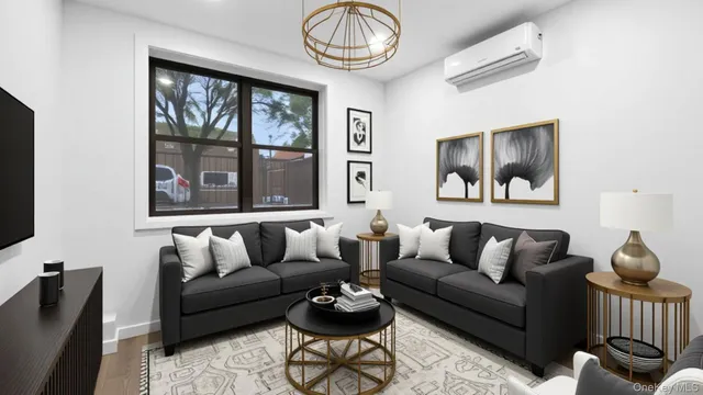 a living room with furniture a window and a flat screen tv