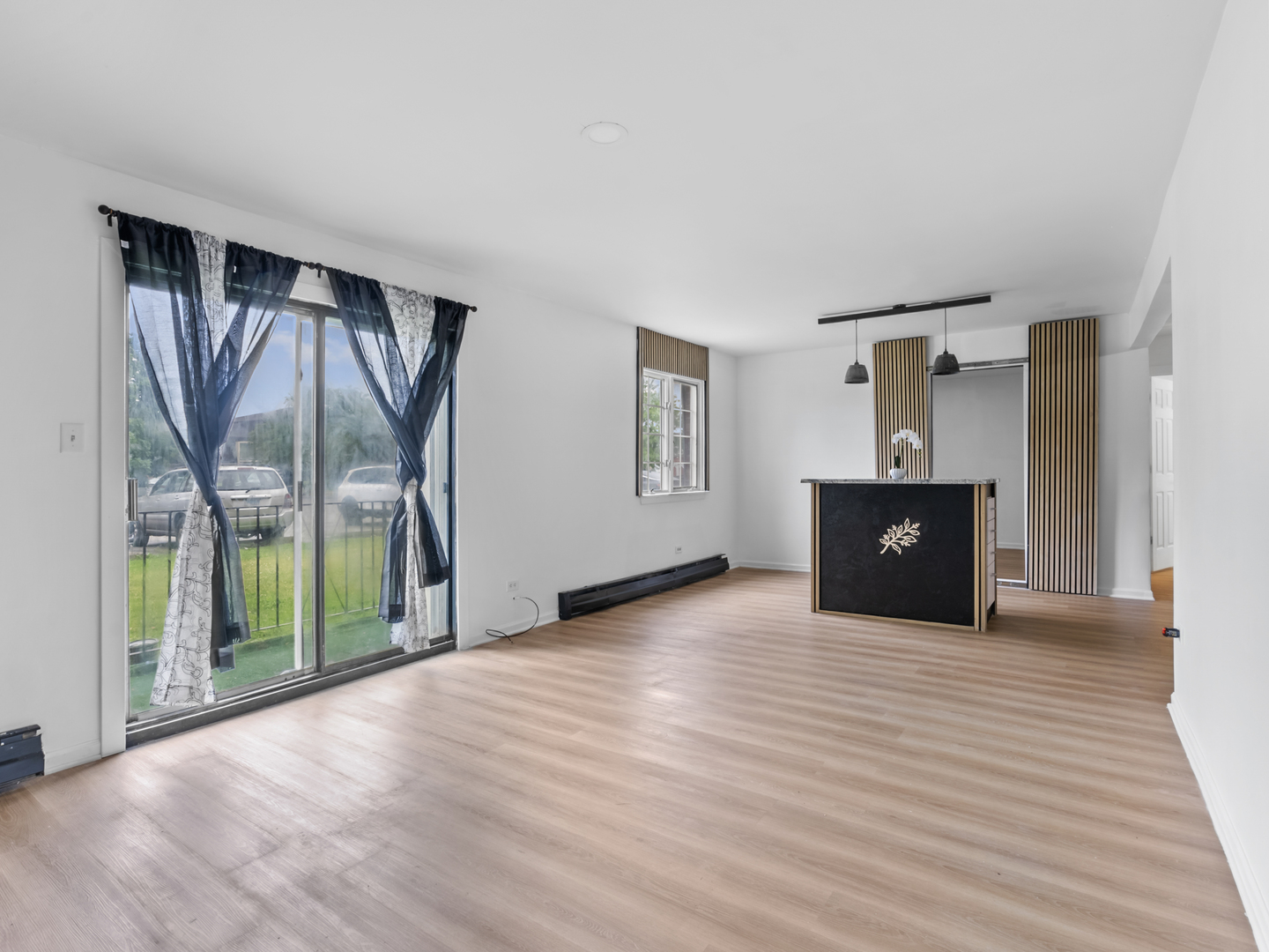 17963 Amherst Court, Unit 102 Country Club Hills, IL 60478 - Photo 2 of 11 a view of an empty room with a window and wooden floor