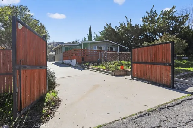 a view of a backyard with wooden fence