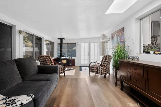 a kitchen with granite countertop white cabinets stainless steel appliances a sink and a window