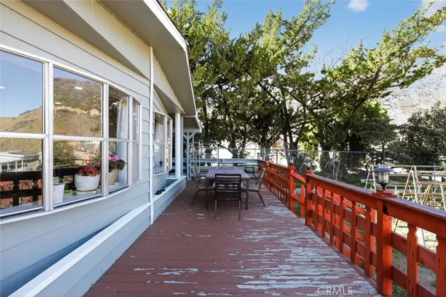 a view of a balcony with wooden benches