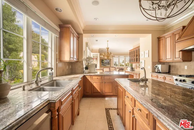 a kitchen with a sink and a large window