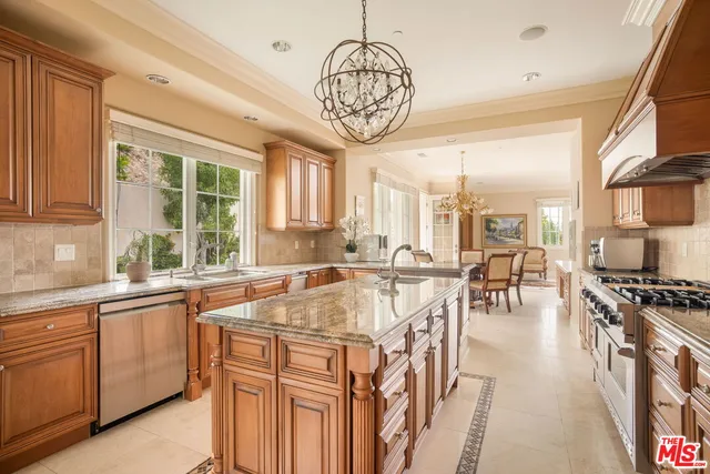 a very nice looking kitchen with a large window appliances and cabinets