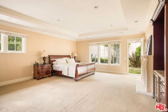 a spacious bedroom with a bed and a couch