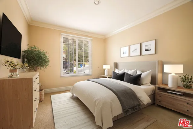 a bedroom with a large bed and a flat screen tv