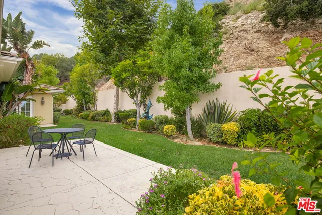 a view of backyard with seating area and green space