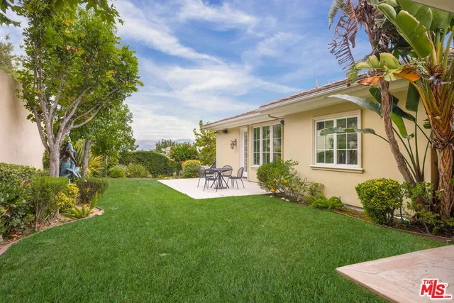 a view of a house with backyard sitting area and garden