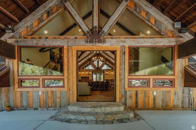 1667 West Tollgate Cyn Road Coalville, UT 84017 - Photo 51 of 61 Rustic-inspired entry featuring stacked stone steps, a timber-framed porch, and a wood-paneled exterior