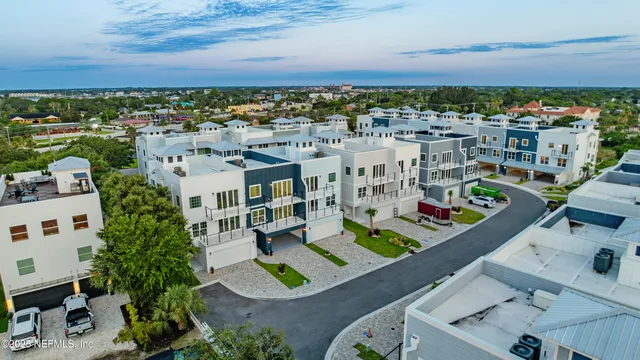 an aerial view of a residential houses with outdoor space
