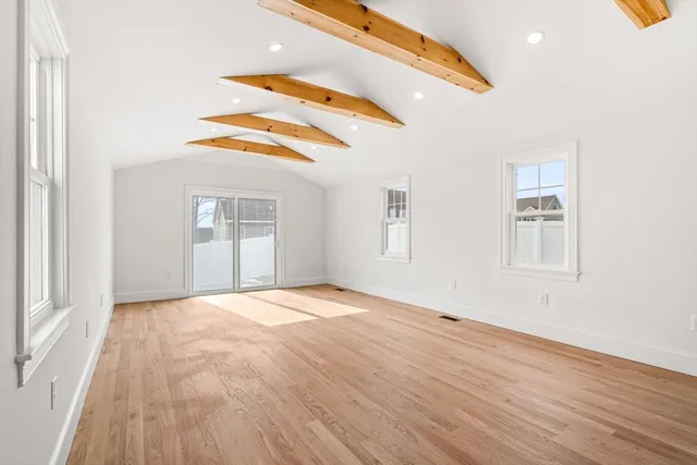 a view of an empty room and wooden floor