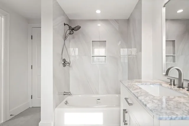 a bathroom with a granite countertop sink a shower and a mirror