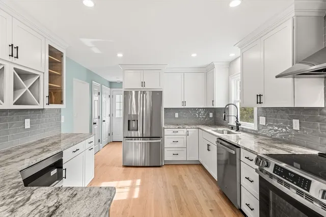 a kitchen with a refrigerator and a sink