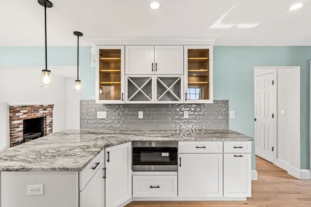 a kitchen with stainless steel appliances granite countertop a stove and cabinets