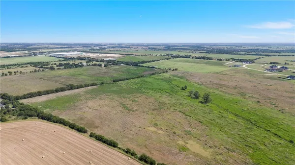 a view of a field with an ocean beach