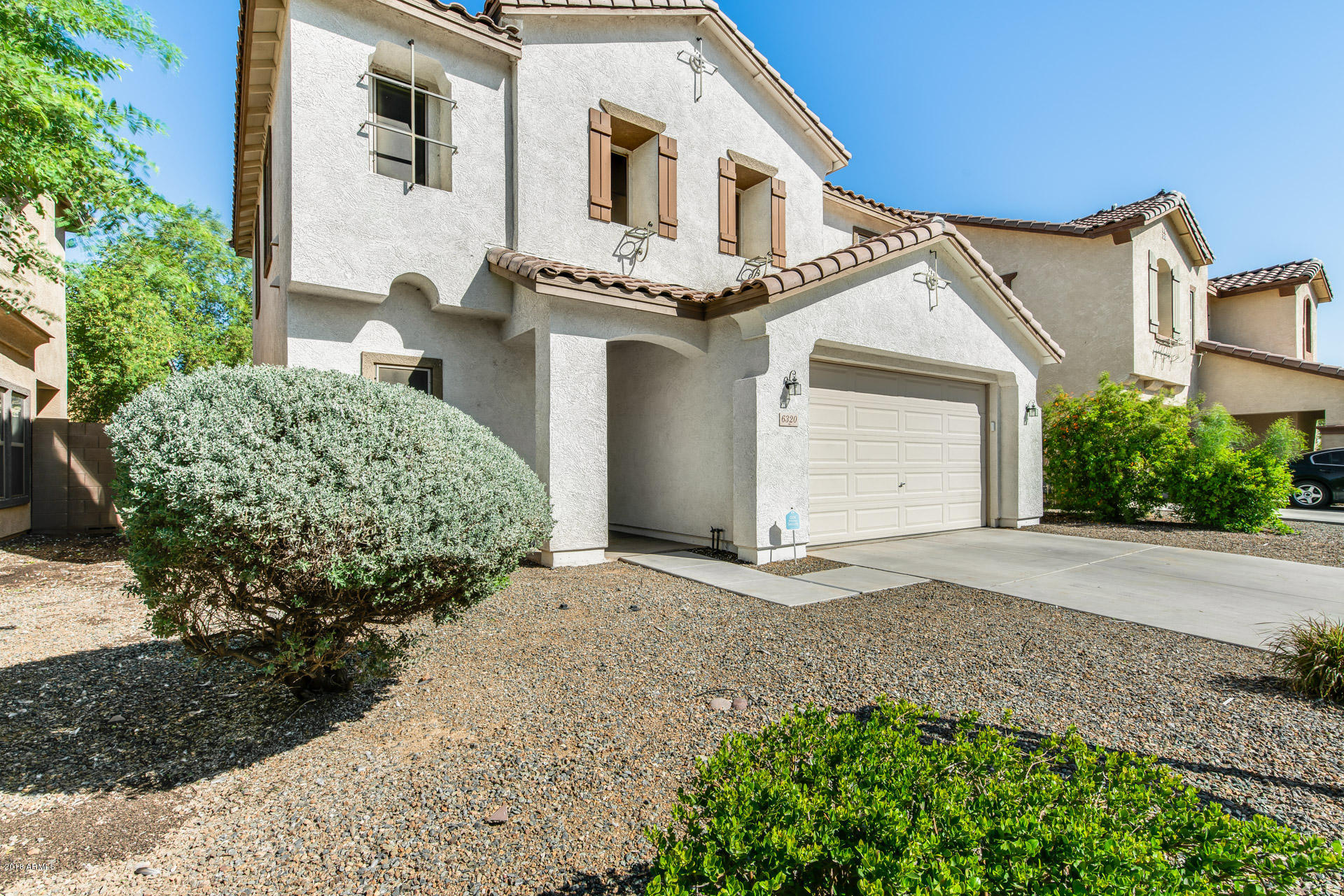 6320 West Beverly Road Laveen, AZ 85339 - Photo 1 of 30 a front view of a house with a yard and garage