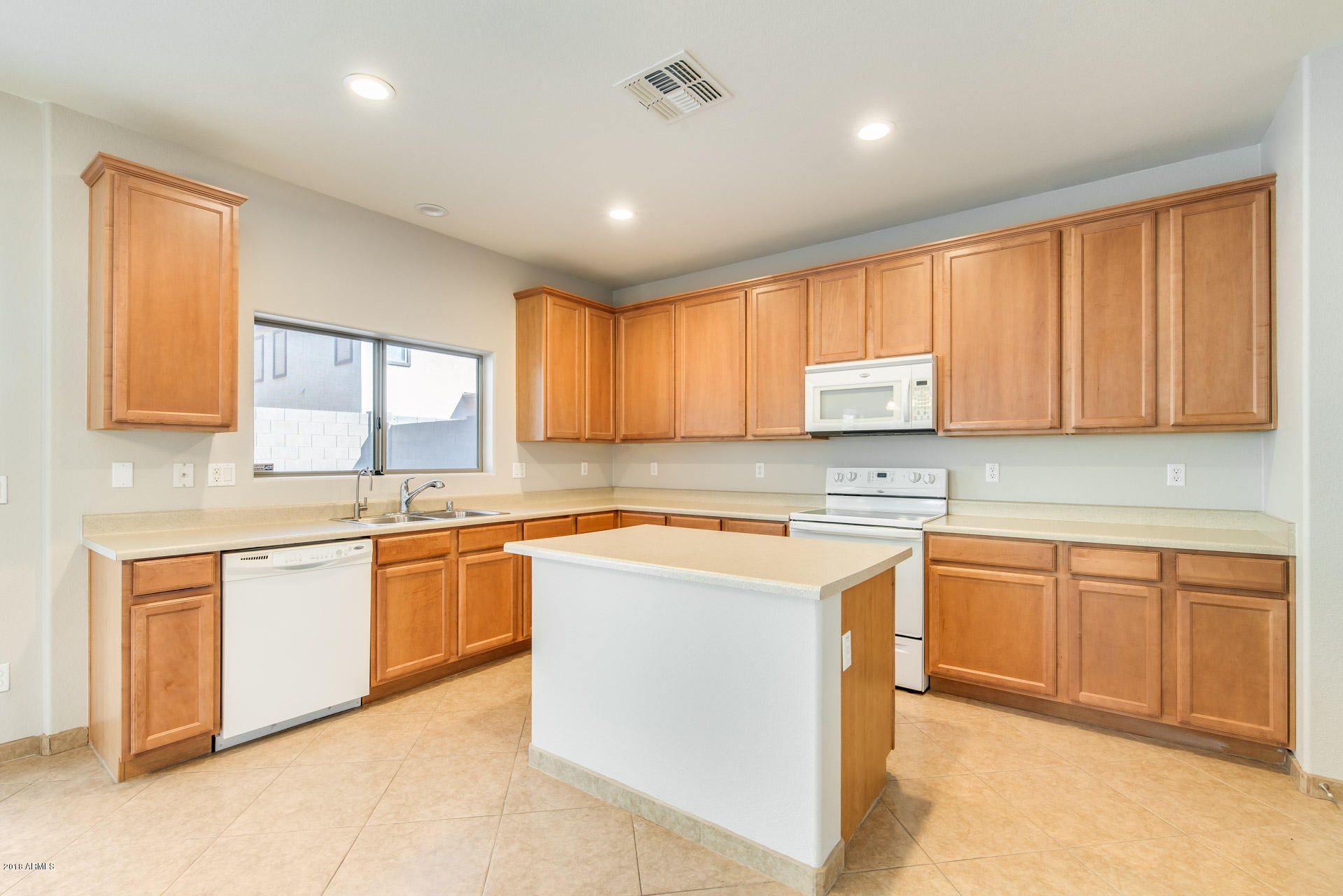 6320 West Beverly Road Laveen, AZ 85339 - Photo 12 of 30 a kitchen with stainless steel appliances granite countertop refrigerator sink and cabinets