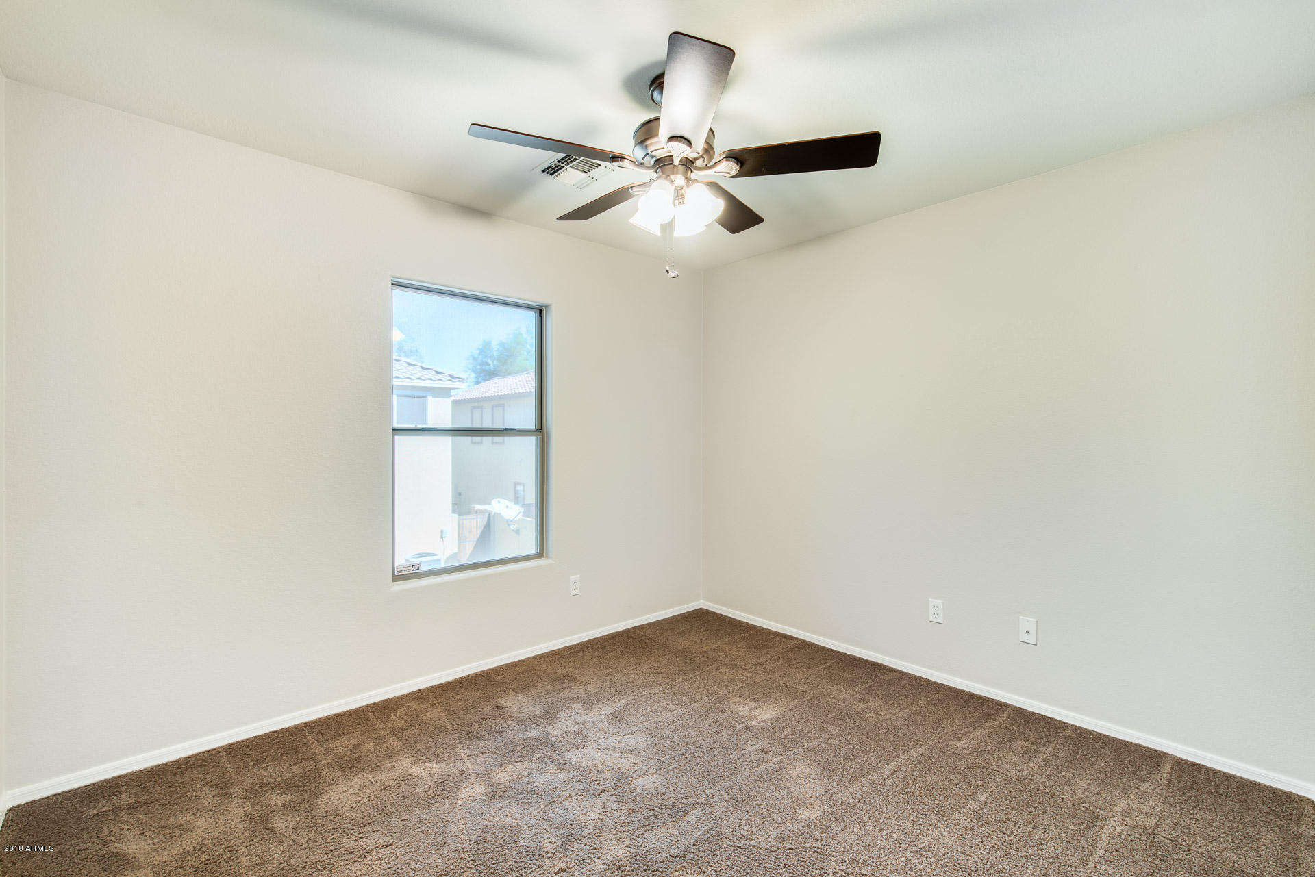 6320 West Beverly Road Laveen, AZ 85339 - Photo 25 of 30 an empty room with windows and fan