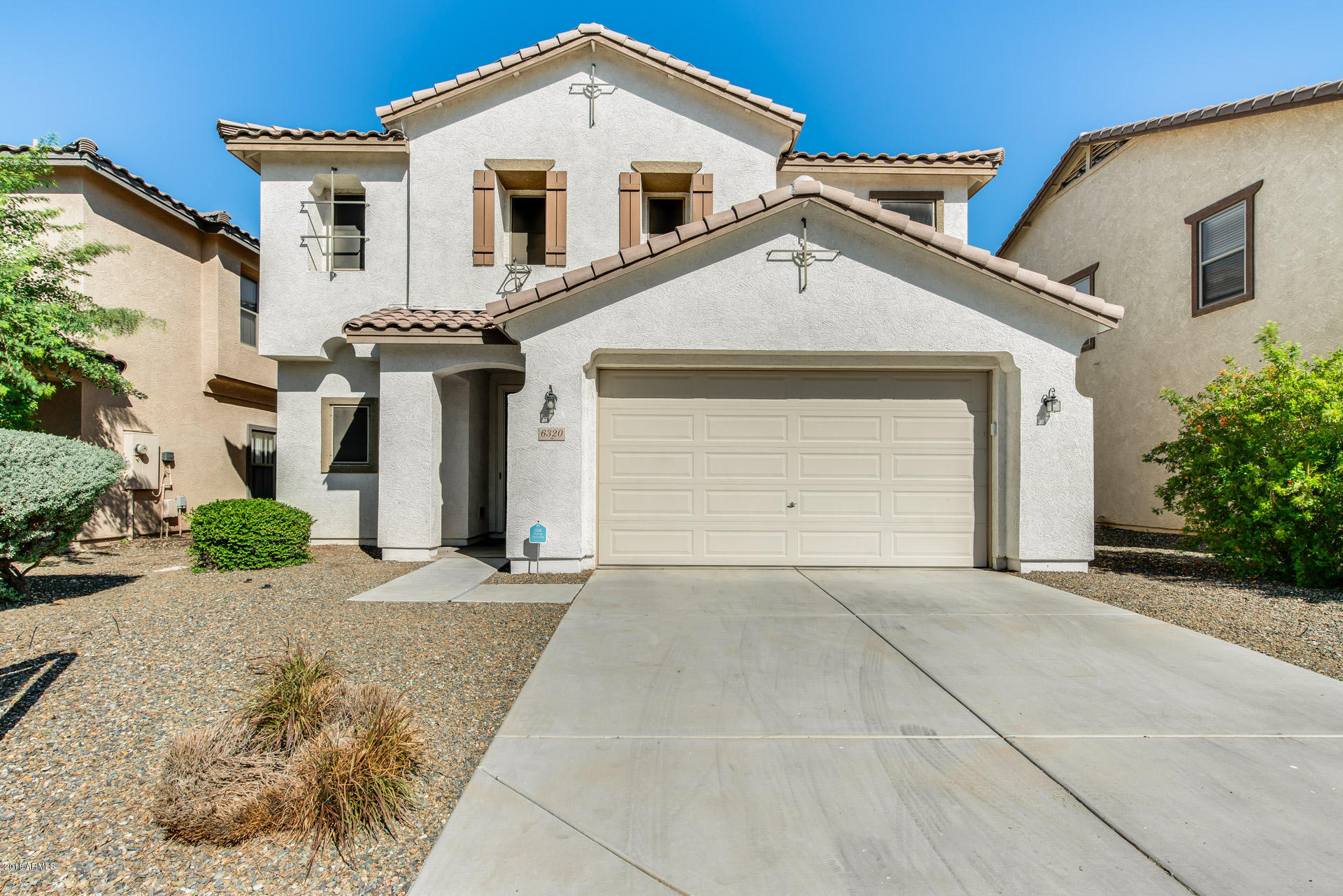 6320 West Beverly Road Laveen, AZ 85339 - Photo 7 of 30 a front view of a house with a yard and garage