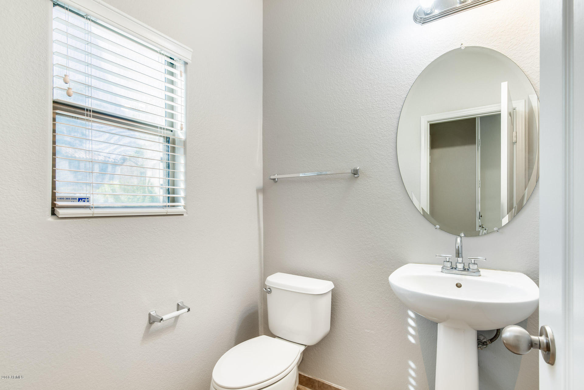 6320 West Beverly Road Laveen, AZ 85339 - Photo 10 of 30 a bathroom with a toilet sink and mirror