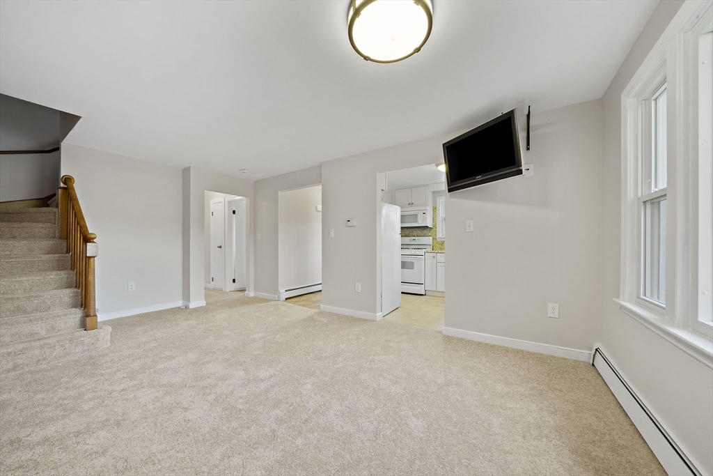 250-252 Mechanic Street Canton, MA 02021 - Photo 11 of 42 a view of an empty room with fire place and a window
