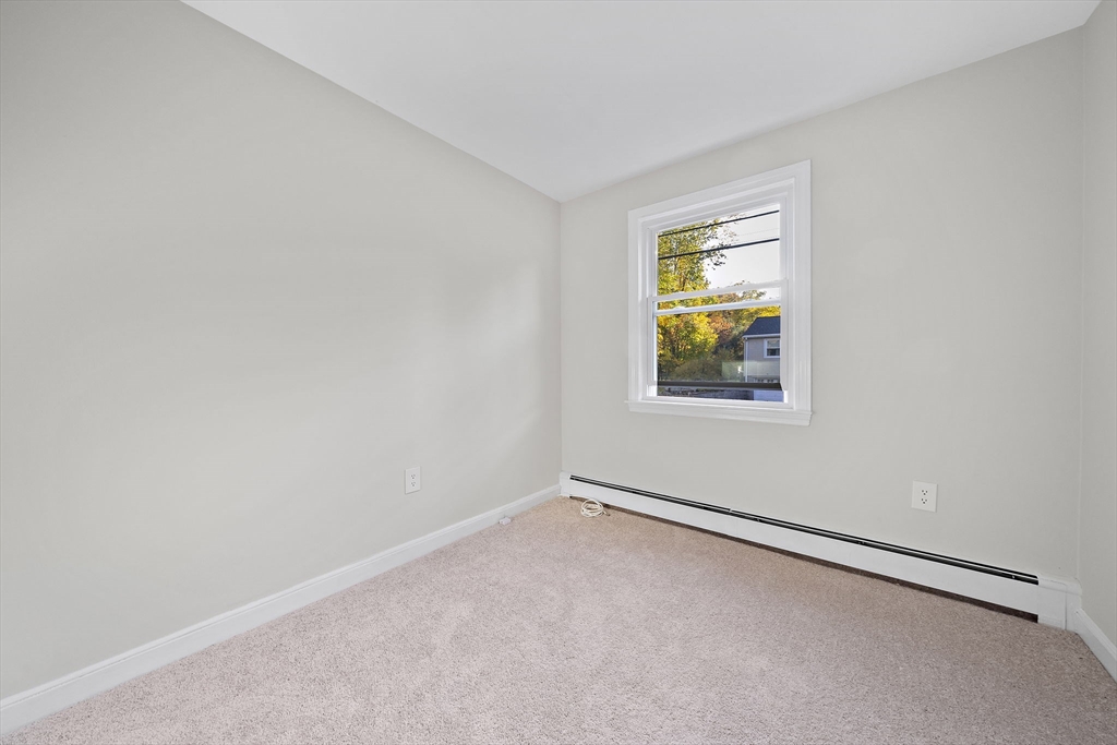 250-252 Mechanic Street Canton, MA 02021 - Photo 15 of 42 an empty room with window and mirror fan