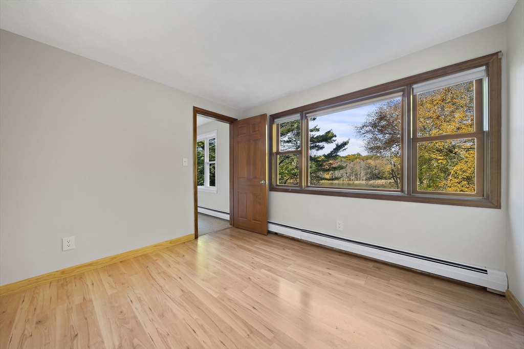 250-252 Mechanic Street Canton, MA 02021 - Photo 22 of 42 a view of an empty room with wooden floor and a window