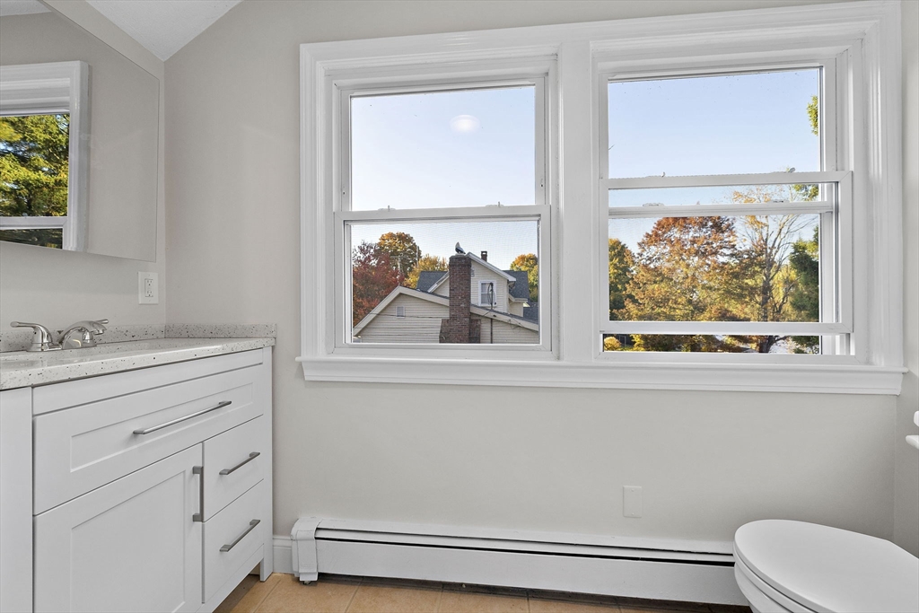 250-252 Mechanic Street Canton, MA 02021 - Photo 24 of 42 a bathroom with a window sink and mirror