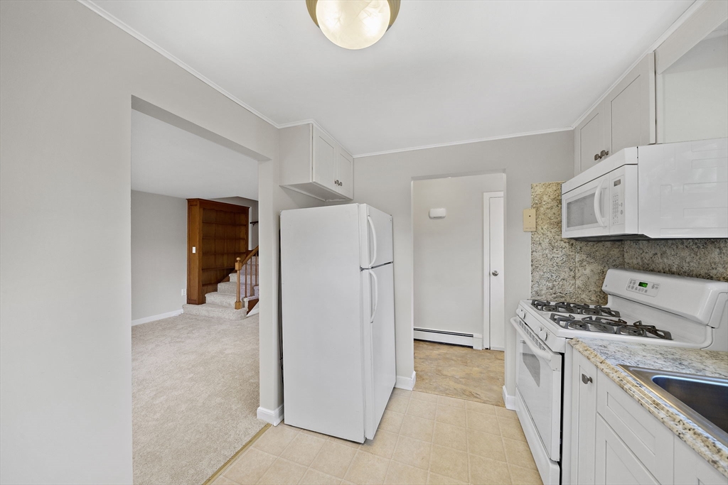250-252 Mechanic Street Canton, MA 02021 - Photo 8 of 42 a kitchen with stainless steel appliances granite countertop a refrigerator and a stove