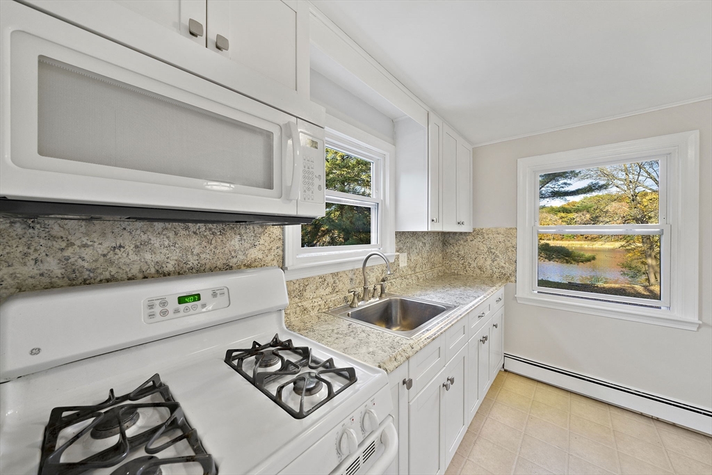 250-252 Mechanic Street Canton, MA 02021 - Photo 9 of 42 a kitchen with a sink stove and microwave
