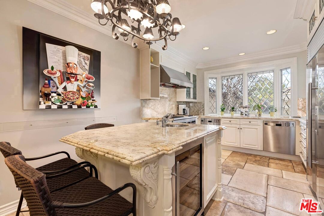 2286 Canyonback Road Los Angeles, CA 90049 - Photo 12 of 40 a kitchen with a stove a sink a refrigerator and a dining table