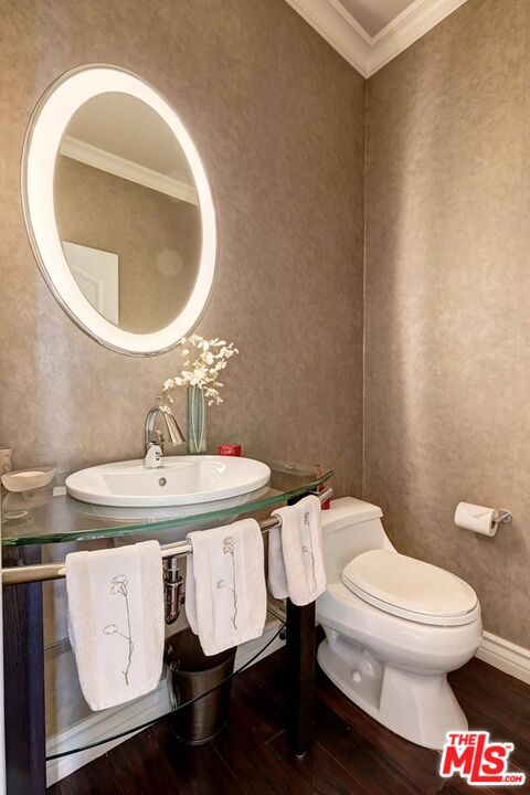 2286 Canyonback Road Los Angeles, CA 90049 - Photo 27 of 40 a bathroom with a toilet sink and mirror