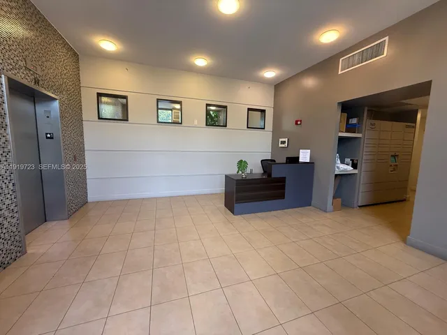 a view of kitchen with refrigerator and cabinets