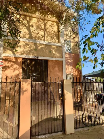 a view of a pathway with a wrought fence