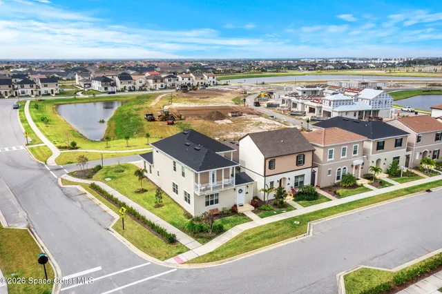 an aerial view of residential building with outdoor space and ocean view