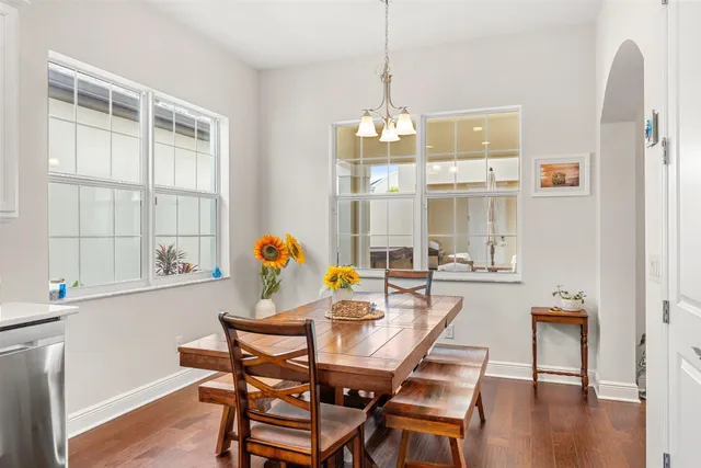 a view of a dining room with furniture wooden floor and a chandelier