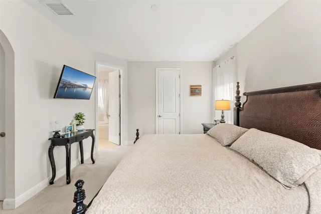 a bedroom with a bed and a painting on the wall