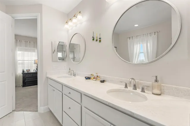 a bathroom with a double vanity sink and a mirror
