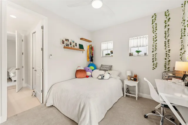 a bedroom with a bed a table and chair