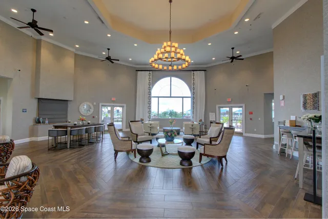a view of a house with a big yard and a large tree