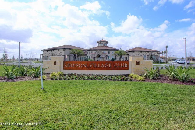 an aerial view of a residential houses with outdoor space and ocean view