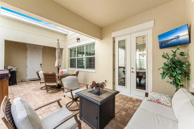 a living room with furniture and potted plants