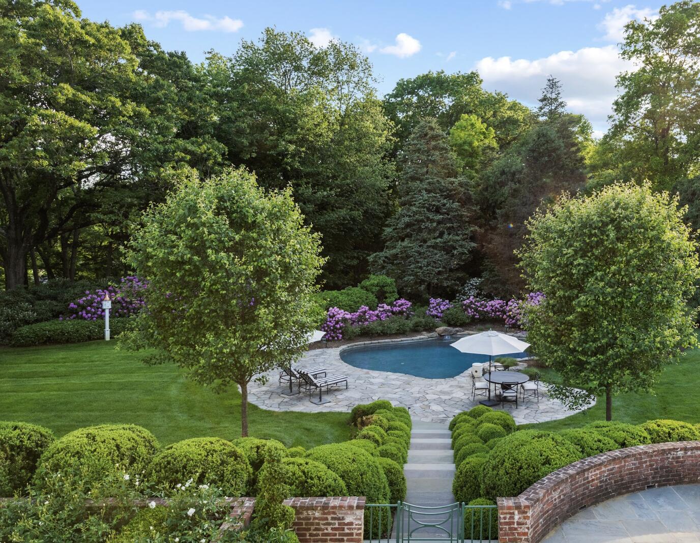 1024 Smith Ridge Road New Canaan, CT 06840 - Photo 36 of 40 a view of a table and chairs in a garden