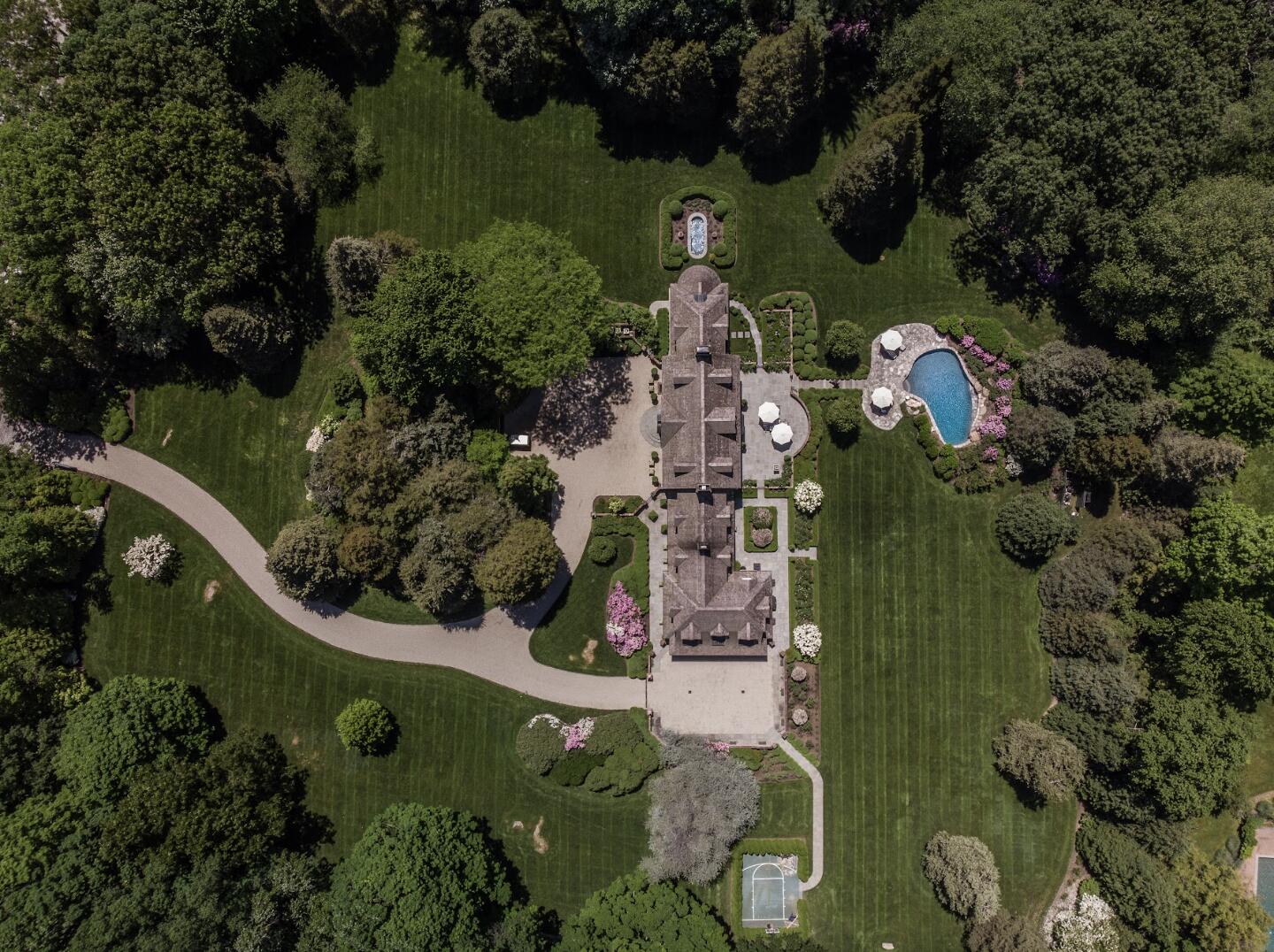 1024 Smith Ridge Road New Canaan, CT 06840 - Photo 40 of 40 an aerial view of a house with a yard swimming pool and outdoor seating