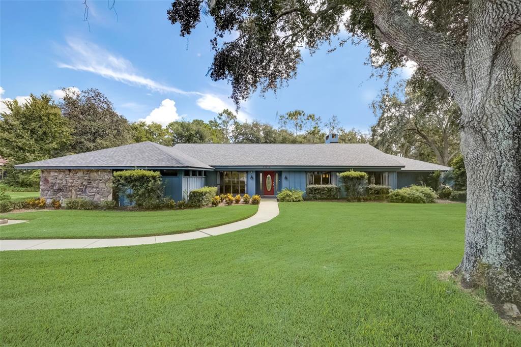 33816 Spring Drive Leesburg, FL 34788 - Photo 1 of 1 a front view of a house with garden