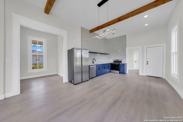 a view of kitchen with refrigerator and window